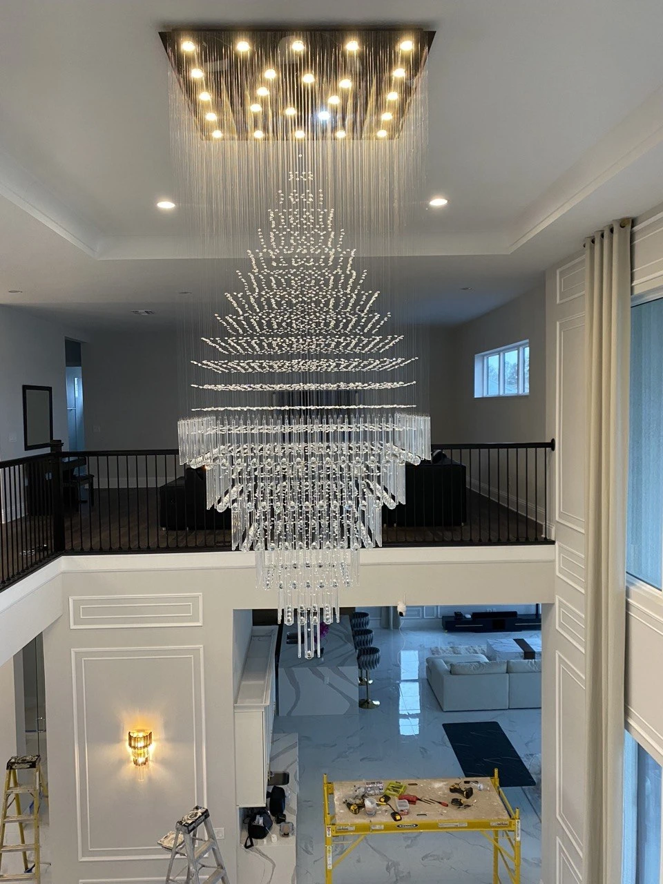 Grand double-height atrium with paneled walls and crystal chandelier