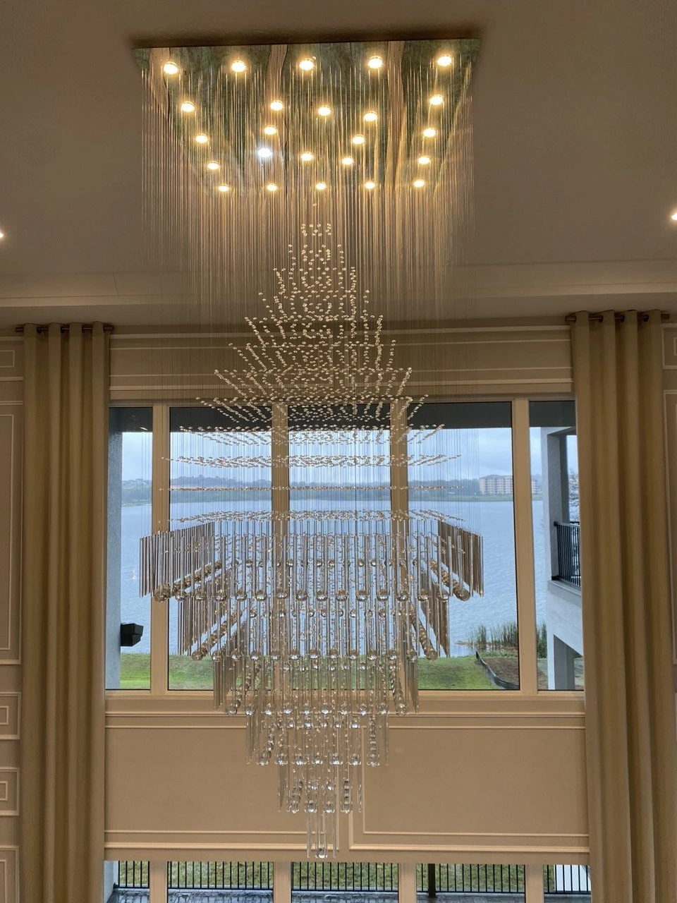 Crystal cascade chandelier in a lakefront foyer