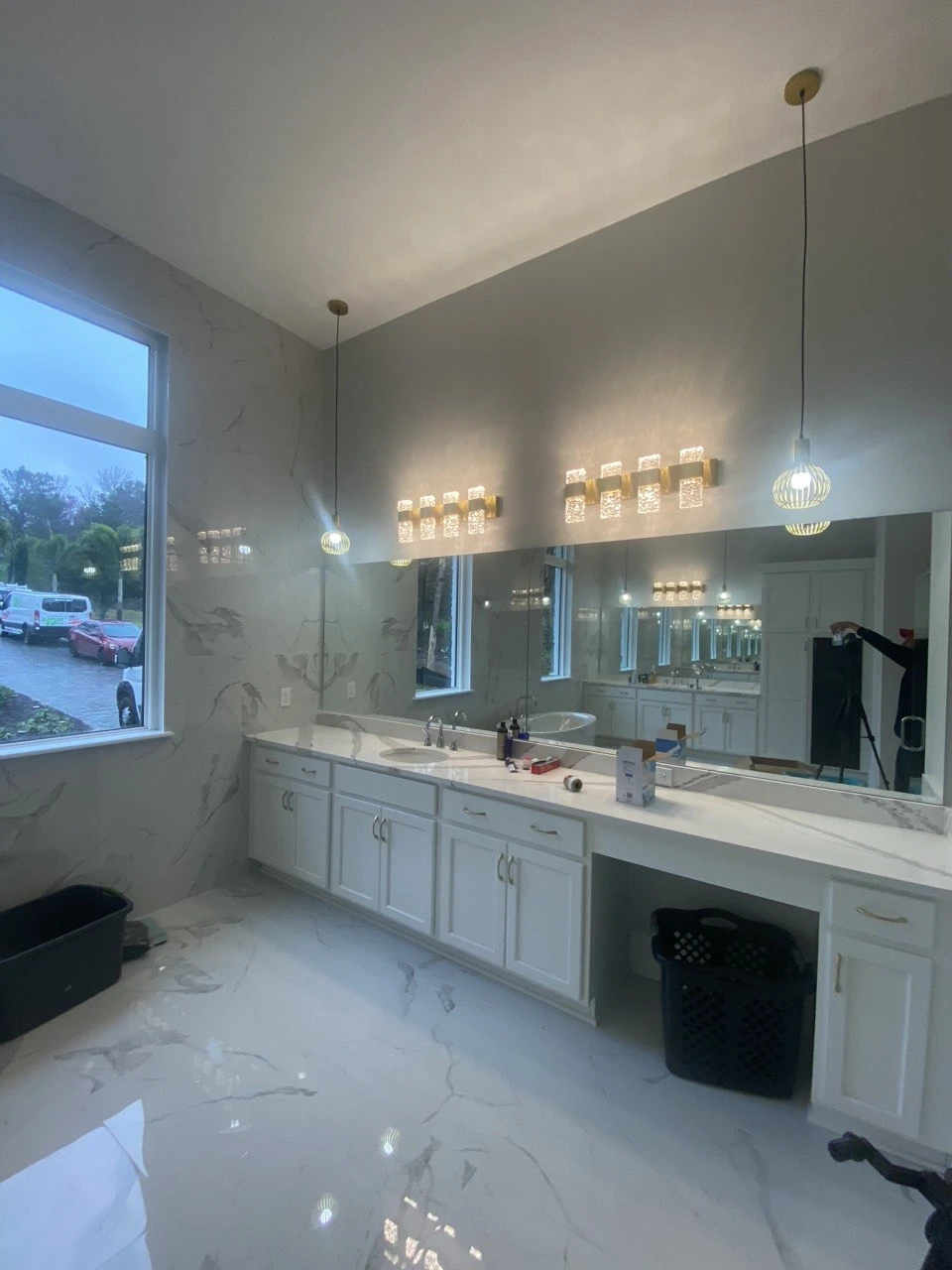 Primary suite bathroom with marble finishes and dual vanity